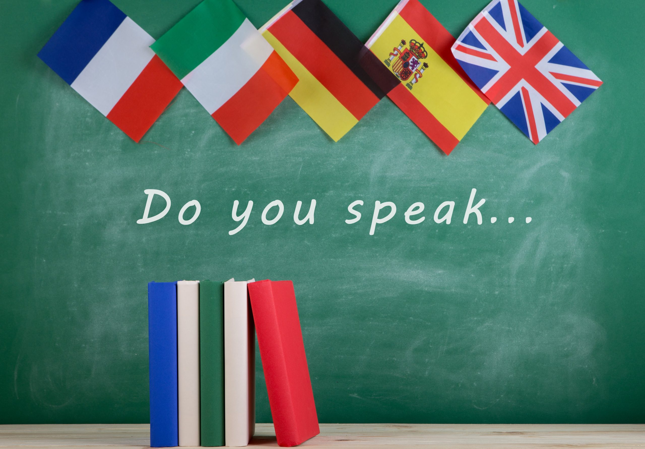 flags-spain-france-great-britain-other-countries-blackboard-with-text-you-speak-books-min (1)